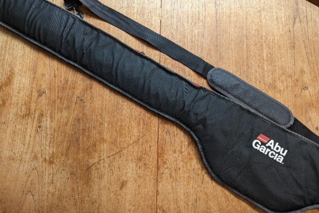 An Abu Garcia Fishing Rod Bag laid out on a wooden table