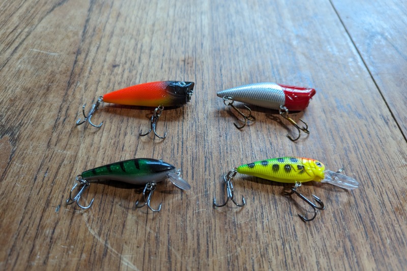 Small, hard, surface lures for pike on a wooden table