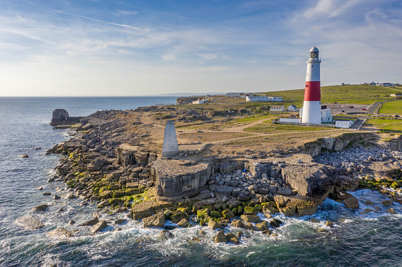 View of the Isle of Portland, its lighthouse and rocky marks