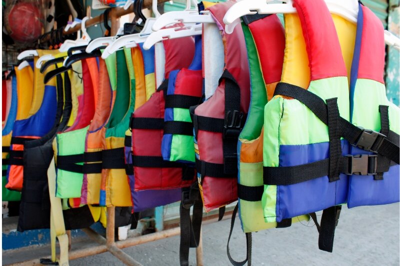 Colourful life jackets hanging up