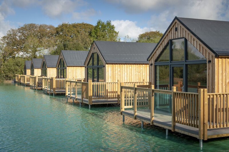 A view of Clawford Lakes lakeside lodges in the sunshine