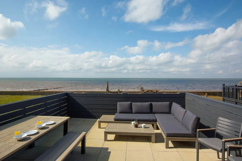 The view of and from the roof terrace over the beach at The Heacham House