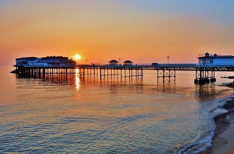 A sunset view over Cromer Pier from the beach