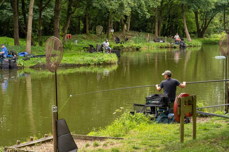 People fishing at one of the main lakes at Reepham Fishery