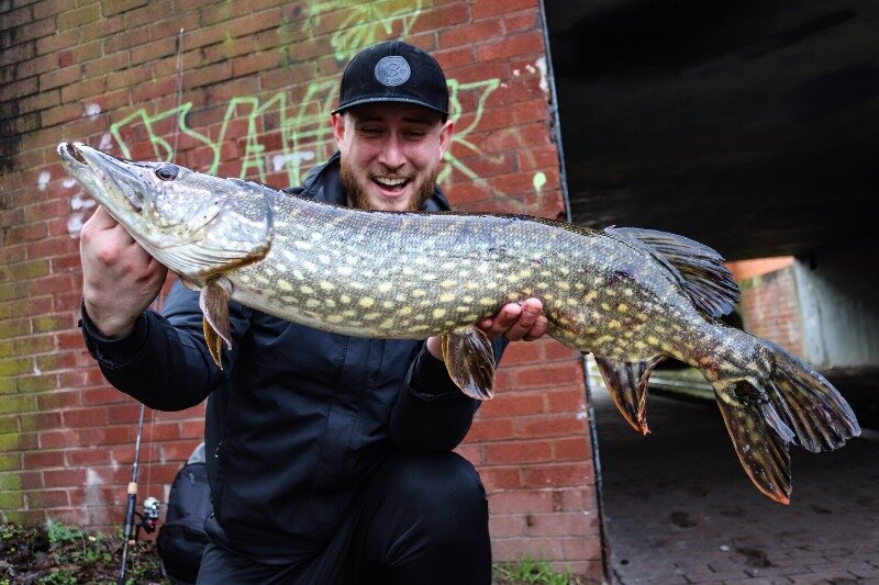 Snagged Bro holding a pike on a Birmingham canal