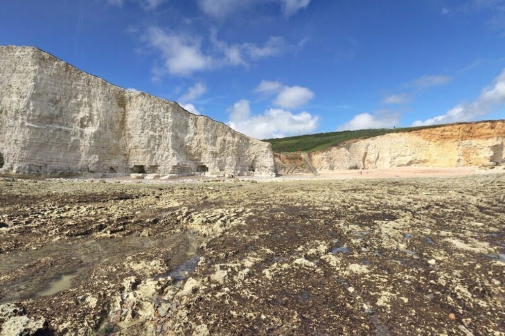 Photograph of the shingle beach and white cliffs down at Cuckmere Haven taken from Google Maps Street View