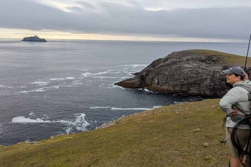 Standing in front of the sea on Dursey Island with a fishing rod in tow